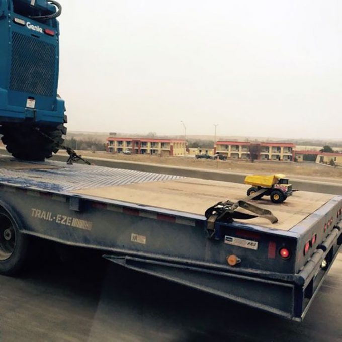 mini truck on a top of a huge truck